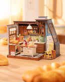 Atmosphärische Präsentation der Robotime Baking Kitchen, umgeben von frischen Brötchen 