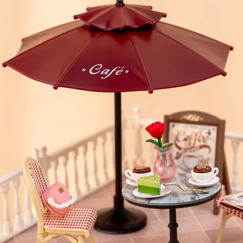 Details des Sonnenschirms, des Tisches und eines Stuhles der Robotime Chic Café Terrasse