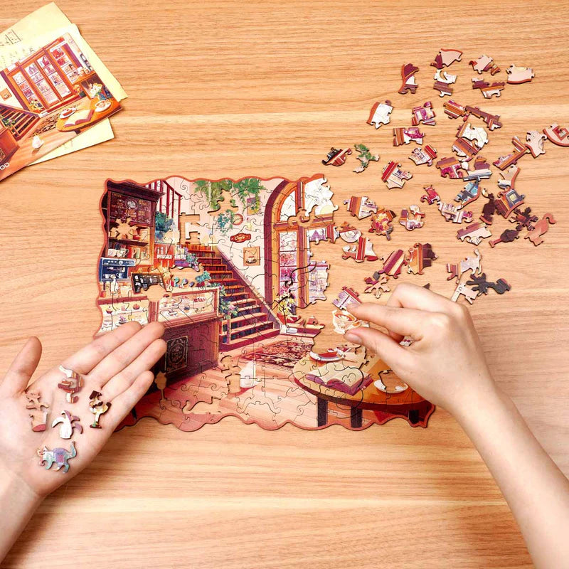 Eine Person ist damit beschäftigt, das Robotime Cozy Winter Café Puzzle zu erstellen