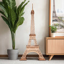 Stimmungsbild des Robotime Eiffel Tower Plus zwischen einer Pflanze und einem Schrank