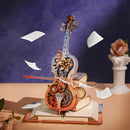 Atmosphärische Präsentation des Robotime Magic Cello – Symphony of Gorgeous Dreams vor einem violetten Hintergrund, umgeben von fliegenden Notenblättern.