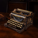 Atmosphärische Präsentation der Robotime Mechanical Typewriter (Classic Version), Holzbausatz einer funktionsfähigen Schreibmaschine in Schwarz und Gold