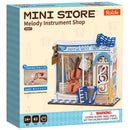 Vorderseite der Verpackung der Robotime Melody Instrument Shop, Bausatz für ein Miniaturhaus einer Musikgeschäft