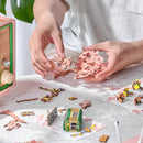 Eine Person baut die Robotime Sakura Dreamy Tour