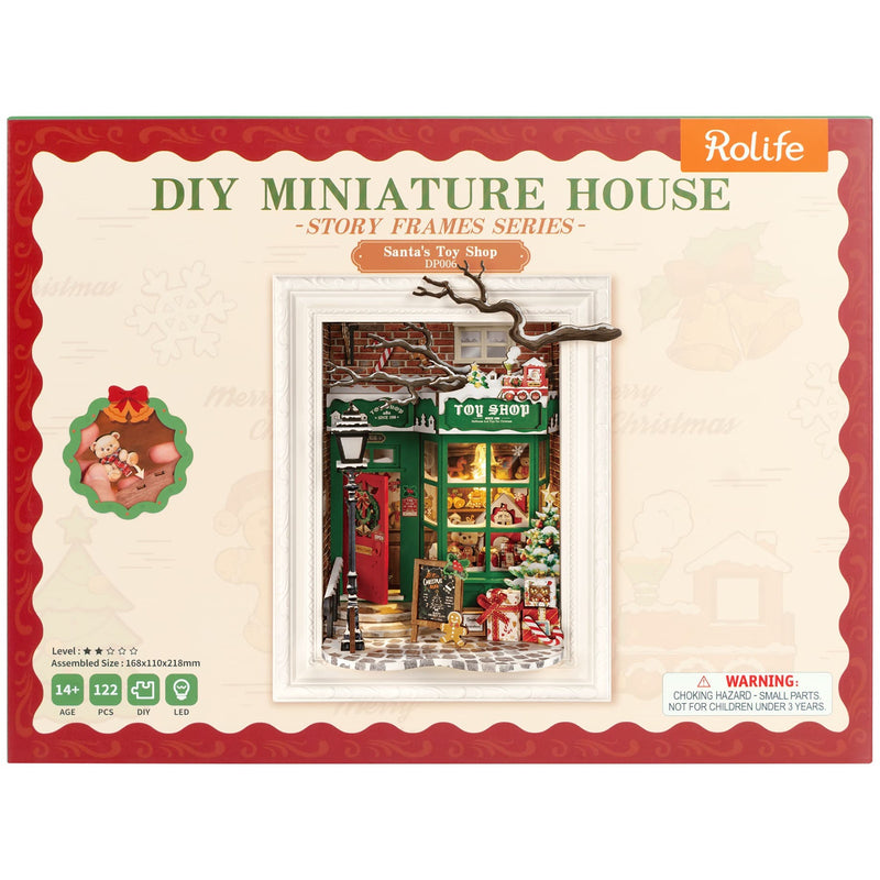 Vorderseite der Verpackung der Robotime Santa’s Toy Shop, Diorama eines weihnachtlich dekorierten Ladens mit Lichtern