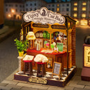 Atmosphärische Präsentation der Robotime Tipsy Cat Bar, Miniaturhaus einer Bar, in der eine Katze auf dem Barhocker schläft