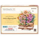 Vorderseite der Verpackung der Robotime Wooden Blooming Book, Holzbausatz eines Blumenstraußes auf einem geschlossenen Buch